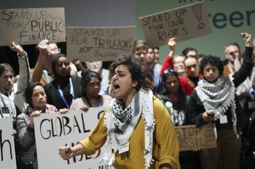 World agrees to climate deal on financial aid for developing countries after summit nearly implodes