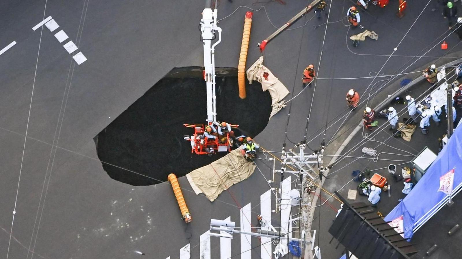 Rescuers race to pull out truck driver stuck in Japan sinkhole for days