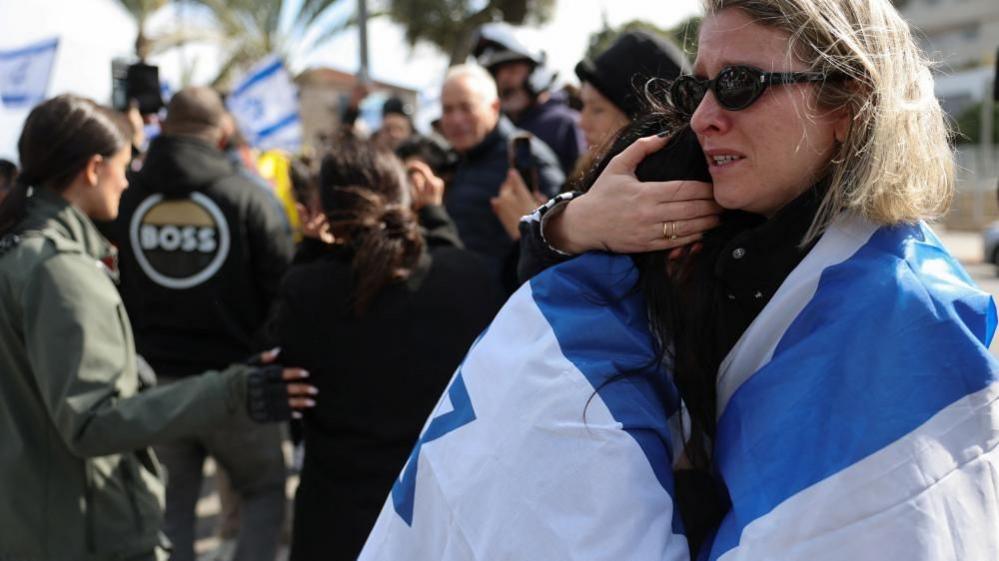 Return of bodies marks day of anguish for Israel