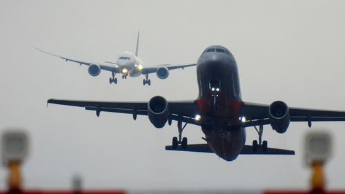 Queensland airports reopen but more than 50 flights cancelled amid wild weather